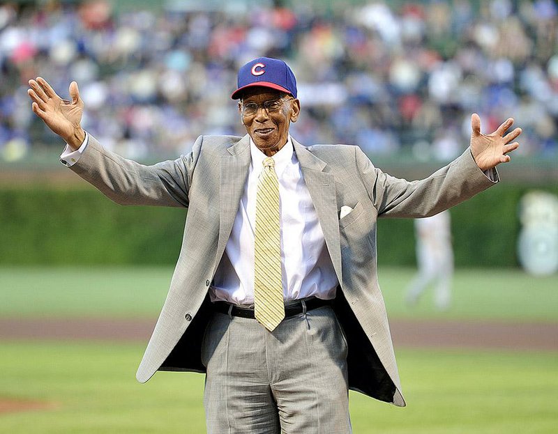 FILE - Int his Aug. 13, 2013, file photl, former Chicago Cubs infielder Ernie Banks waves to the crowd before the Cubs' baseball game against the Cincinnati Reds in Chicago. Banks, the two-time MVP who never lost his boundless enthusiasm for baseball despite years of playing on losing Cubs teams, died Friday night, Jan. 23, 2015. He was 83. The Cubs announced Banks' death, but did not provide a cause. (AP Photo/Jim Prisching, File)