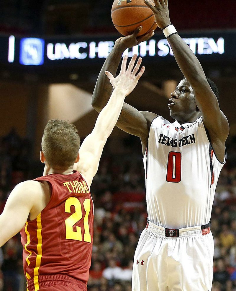 Texas Tech's Devaugntah Williams scores over Iowa State’s Matt Thomas during an NCAA college basketball game in Lubbock, Texas, Saturday, Jan. 24, 2015. (AP Photo/Lubbock Avalanche-Journal, Tori Eichberger)