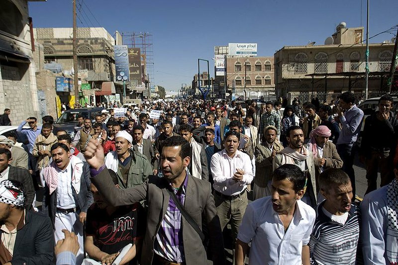 Protesters chant slogans against Houthi Shiite rebels who hold the capital, Sanna, amid a power vacuum as they march on a street in Sanaa on Saturday, Jan. 24, 2015. Some 20,000 marched Saturday across the capital, where demonstrators converged on the house of President Abed Rabbo Mansour Hadi, who resigned Thursday along with his Cabinet. (AP Photo/Hani Mohammed)