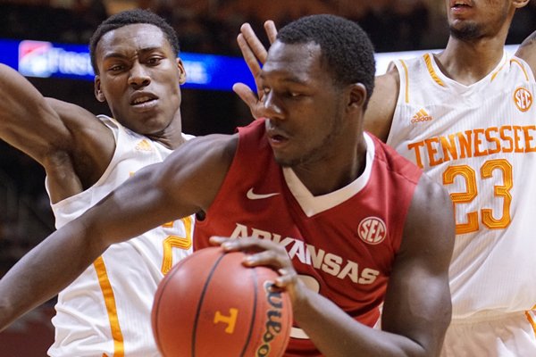 Arkansas' Alandise Harris (2) can't find an opening as he is guarded by Tennessee's Willie Carmichael III (24) and Drek Reese (23) in the second half of an NCAA college basketball game Tuesday, Jan. 13, 2015, in Knoxville, Tenn. (AP Photo/Patrick Murphy-Racey)