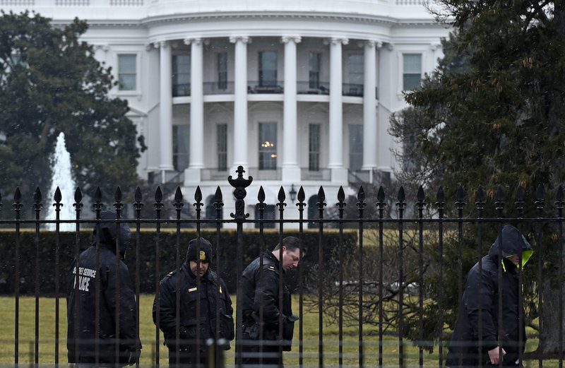 Secret Service officers search the south grounds of the White House in Washington on Monday, Jan. 26, 2015. A device, possibly an unmanned aerial drone, was found on the White House grounds during the middle of the night while President Barack Obama and the first lady were in India, but his spokesman said Monday that it posed no threat. 