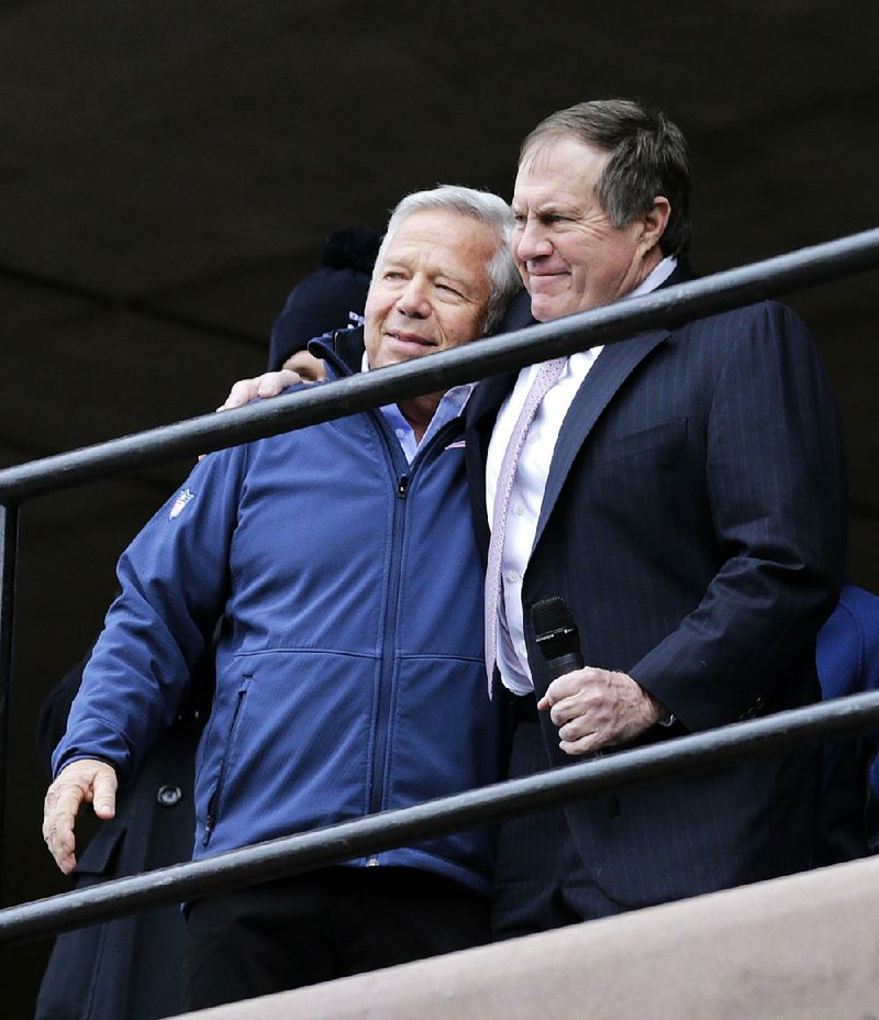 New England Patriots head coach Bill Belichick, right, embraces team owner Robert Kraft during an NFL football send-off rally at City Hall in Boston Monday, Jan. 26, 2015. The Patriots play the Seattle Seahawks in Sunday's Super Bowl XLIX in Glendale, Ariz. (AP Photo/Charles Krupa)