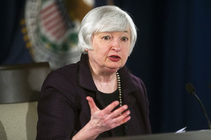 FILE - In this Dec. 17, 2014 file photo, Federal Reserve Chair Janet Yellen speaks with reporters at the Federal Reserve in Washington. The Federal Reserve ended 2014 with a pledge to be “patient” in raising interest rates from record lows. The way things are going, its patience may endure for a long while. (AP Photo/Cliff Owen, File)
