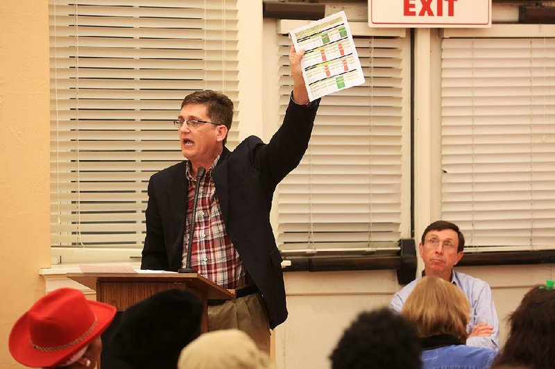 Jim Ross, who at the time was still a Little Rock School Board member, speaks to a full house Monday during a forum on the future of the Little Rock School District. Seated right is Sam Ledbetter, chairman of the state Board of Education. The Board of Education took control of the district Wednesday. 