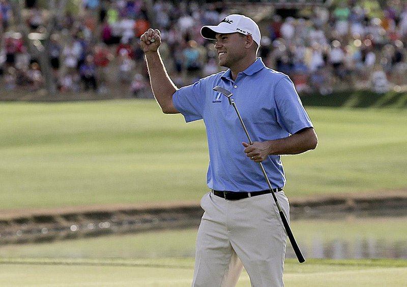 Bill Haas celebrates after winning the Humana Challenge golf tournament on the Palmer Private course at PGA West on Sunday, Jan. 25, 2015 in La Quinta, Calif. (AP Photo/Chris Carlson)