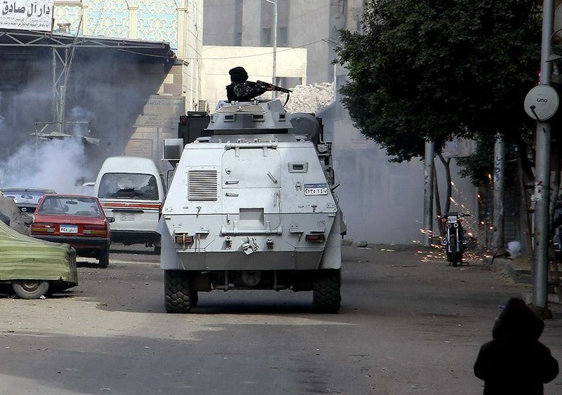 Egyptian security forces fire in the Cairo suburb of Matariyah, Egypt, Sunday, Jan. 25, 2015. Egypt tightened security in Cairo and other cities Sunday as police moved to break up scattered protests marking the anniversary of the 2011 uprising that toppled autocrat Hosni Mubarak, killing at least a dozen , injuring at least 21 and arresting dozens. The deaths occurred when police clashed with supporters of the outlawed Muslim Brotherhood group in Cairo and Alexandria, security officials said. (AP Photo/Ahmed Abdel Fattah) EGYPT OUT