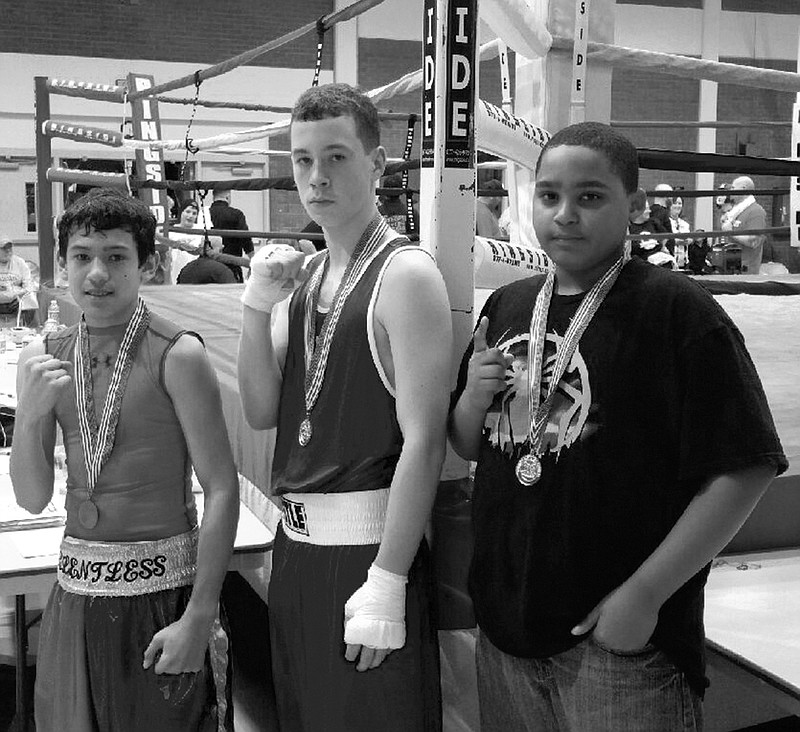 Submitted photo Four members of the Hot Springs Boys and Girls Club boxing team competed in the Region 6 Silver Gloves amateur regional tournament Jan. 15-17 in North Little Rock, with two first-place finishes and one second against other state champions from Texas, Oklahoma, Louisiana, Mississippi and Tennessee. Noah Porter, middle, won the 156-pound class of the 12-13 age group while Makale Coleman, right, claimed the 12-13 heavyweight title, both scheduled to compete in the national tournament Feb. 4-7 in Independence, Mo. Russell Wade, left, was runner-up in the 95-pound class of the 14-15 age group. Hose Arzola, not pictured, competed in the 10-11 85-pound division.