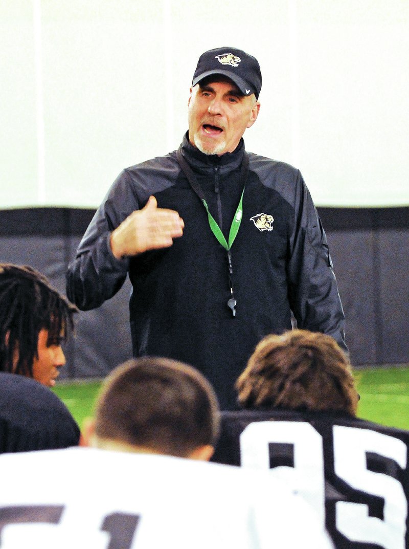 File Photo Barry Lunney Sr. addresses the Bentonville football team during practice Dec. 9, 2013, in the school&#8217;s Tiger Athletic Complex.
