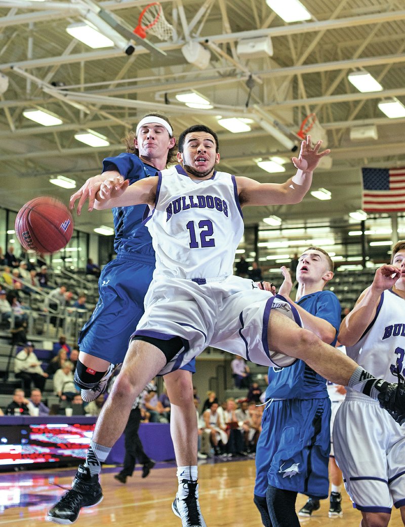 NWA Democrat-Gazette/ANTHONY REYES &#8226; @NWATONYR Tre Moses, Fayetteville senior, shoots as Harrison Heffley, Rogers High junior, defends Monday at Bulldog Gymnasium in Fayetteville.