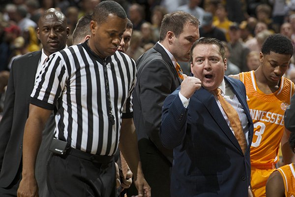 Tennessee coach Donnie Tyndall, right, argues a call with a referee during a timeout in the second half of an NCAA college basketball game against Missouri on Saturday, Jan. 17, 2015, in Columbia, Mo. Tennessee won 59-51. (AP Photo/L.G. Patterson)