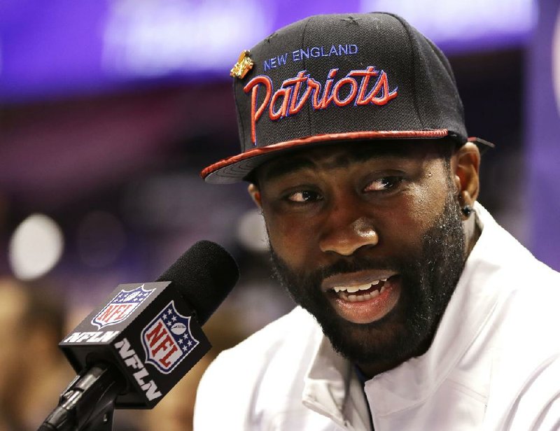 New England Patriots' Darrelle Revis answers questions during media day for NFL Super Bowl XLIX football game Tuesday, Jan. 27, 2015, in Phoenix. 