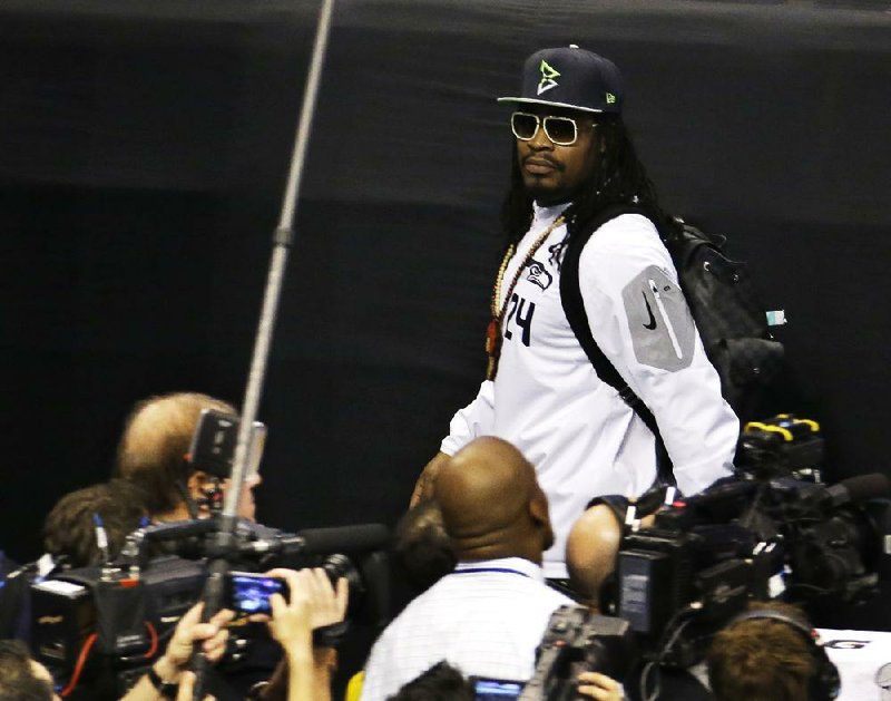 Seattle Seahawks' Marshawn Lynch leaves at the beginning of media day for NFL Super Bowl XLIX football game Tuesday, Jan. 27, 2015, in Phoenix. 