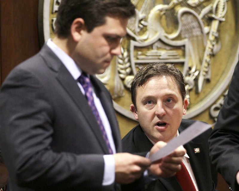 Senate President Pro Tempore Jonathan Dismang (left) and House Speaker Jeremy Gillam confer Tuesday during a meeting of the Joint Budget Committee. 