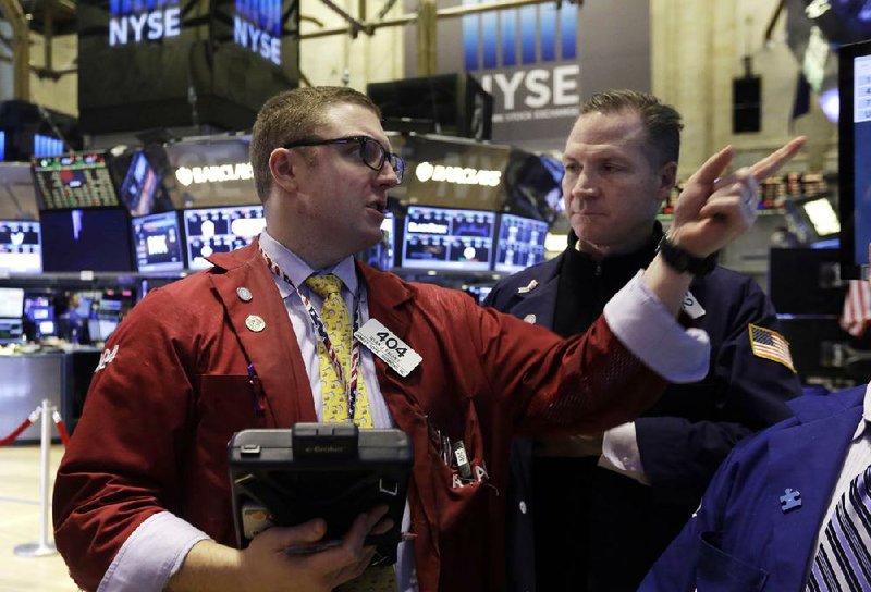 Traders Ryan Falvey (left) and Christopher Crotty work Tuesday on the floor of the New York Stock Exchange. 