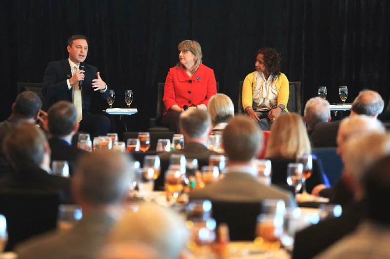Jared Henderson, project manager of the Forward Arkansas organization, talks about the state of education during a Rotary Club luncheon at the Clinton Presidential Center in Little Rock on Tuesday. Kathy Smith of the Walton Family Foundation (center) and Sherece West-Scantlebury of the Winthrop Rockefeller Foundation also spoke. 