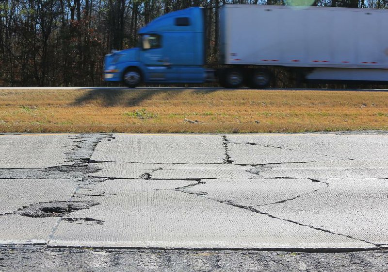 Traffic flows Tuesday on Interstate 30 eastbound across from cracked pavement in a test section of the westbound lanes between mile markers 110 and 109 south of Benton.