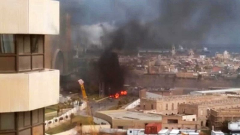 The Corinthia Hotel is seen under attack Tuesday in Tripoli, Libya, in this image made from video posted by a Libyan blogger. The attack, which included a car bombing, struck the hotel, which sits along the Mediterranean Sea. 