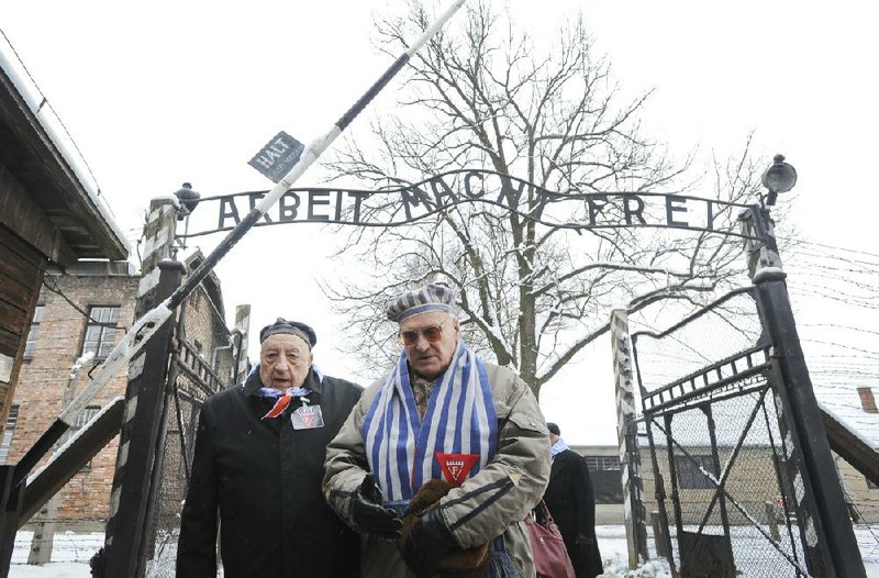 Holocaust survivors walk through the gate of the Auschwitz death camp Tuesday in Oswiecim, Poland. 