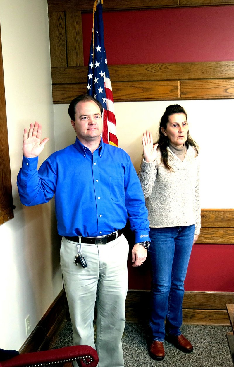 Photo by Mike Eckels David Sutton (left) and Sandy Duncan take the oath of office Jan. 12 in the city council chamber at Decatur City Hall as they begin their new terms on the city council.