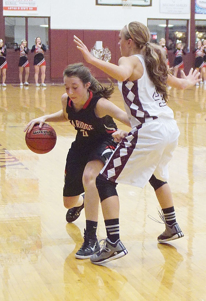 Photograph by Randy Moll, Westside Eagle Observer Lady Blackhawk Avery Dayberry, freshman, tried to push past a Lady Pioneer defender in the game Friday night in Gentry.