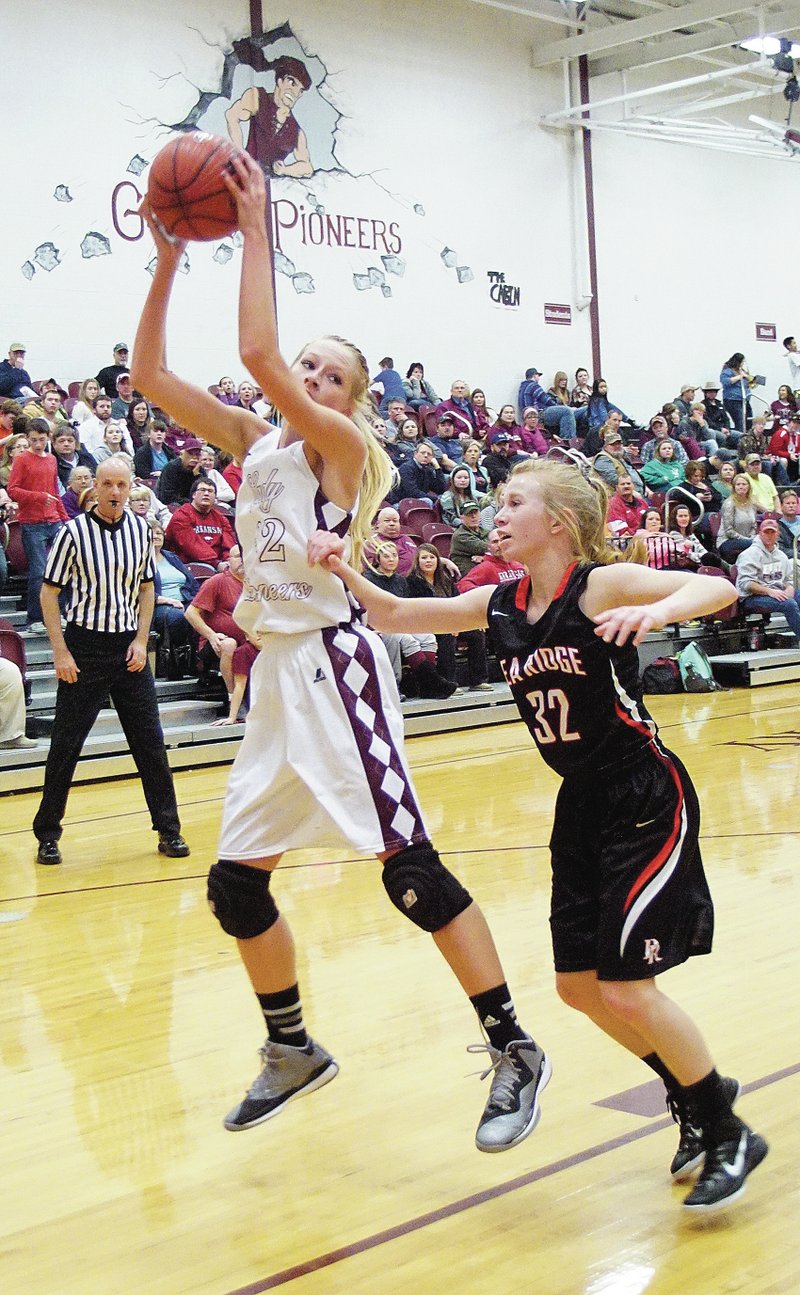Photo by Randy Moll Gentry&#8217;s Lauren Little grabs a rebound and keeps it from Kealy Skaggs of Pea Ridge during play between the two teams on Friday in Gentry.