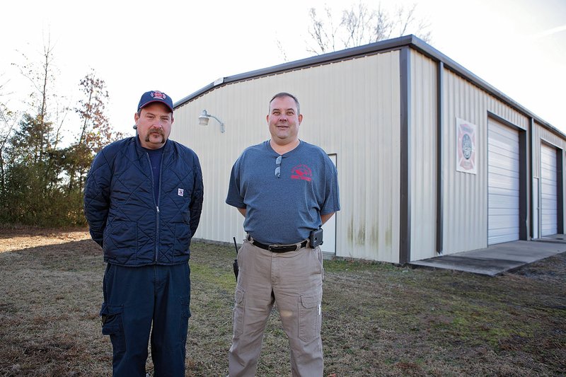 Keith Hillman, left, director of emergency management for the Vilonia Fire Department, and K.C. Williams, deputy director of emergency management, stand in front of Vilonia Fire Station No. 2, which will receive an addition to house more equipment. The project will be paid for with a grant. Grants were also received to add four tornado sirens in Vilonia.