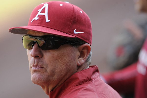 Arkansas coach Dave Van Horn watches from a dugout during practice Friday, Jan. 23, 2015, at Baum Stadium in Fayetteville.