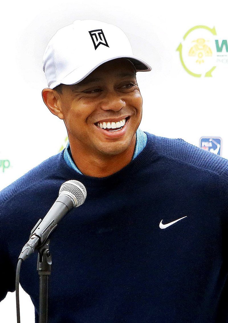 Tiger Woods talks to the media after playing a practice round at the Phoenix Open golf tournament on Tuesday, Jan. 27, 2015, in Scottsdale, Ariz.