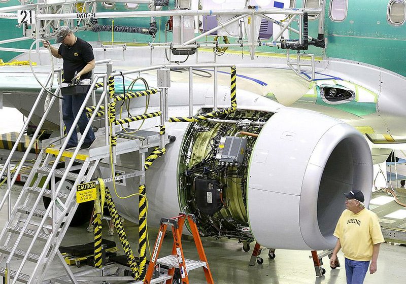 Employees work near an engine for a Boeing 737-800 as the plane was being assembled last month at a Boeing plant in Renton, Wash.  