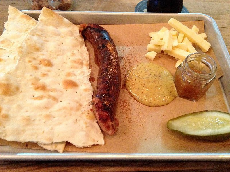 Kielbasa comes with lavash (flatbread), stone-ground mustard, peach marmalade, white cheddar and pickles at the Tap Room at Lost 40 Brewing. 