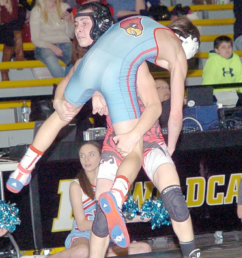 FILE PHOTO MCDONALD COUNTY PRESS McDonald County&#8217;s Jakob Gerow lifts Webb City&#8217;s Riley McFall into the air on the way to recording a pin in a recent match during a triangular at Neosho High School.