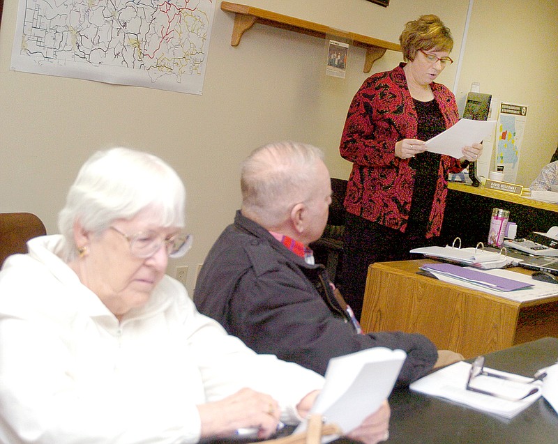 RICK PECK MCDONALD COUNTY PRESS Kimberly Bell (right) McDonald County Clerk, reads her budget message with John and Dolores Fitts, of Noel in attendance at a public hearing Monday prior to the McDonald County Commission passing the 2015 budget.