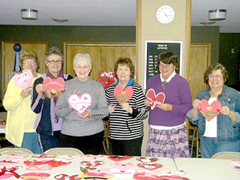 COURTESY PHOTO ESA members look over the Valentine door hangers made for residents of Golden Living Center in Anderson.