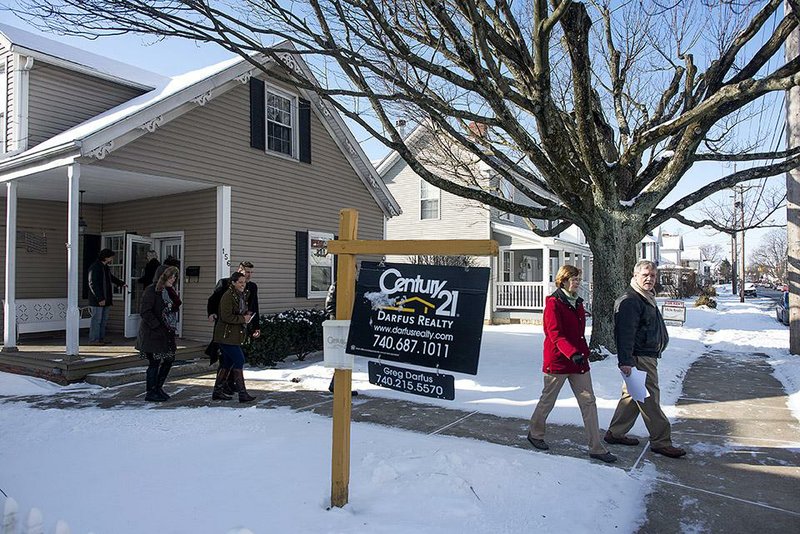 Real estate agents and mortgage brokers leave a home earlier this month in Lancaster, Ohio, after touring the house. 