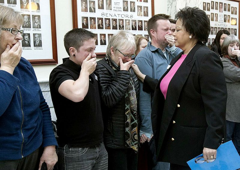 Idaho state Sen. Cherie Buckner-Webb, a Democrat, consoles gay-rights advocates Thursday after an Idaho House committee vote that stalled the bill they supported. 