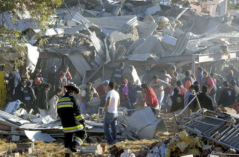 Rescuers and emergency workers comb the rubble Thursday of a maternity and children’s hospital in Mexico City after a gas delivery truck sprang a leak and exploded outside the hospital kitchen, leaving at least one woman and one infant dead, and more than 60 people injured. 