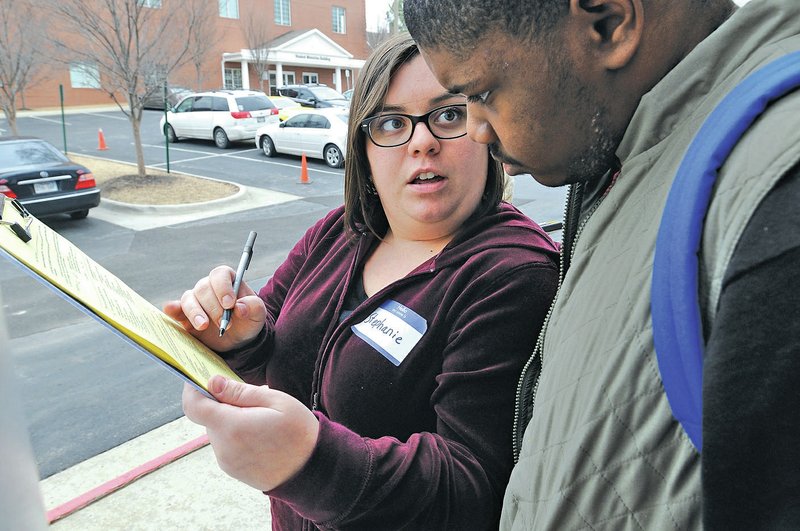 NWA Democrat-Gazette/ J.T. WAMPLER Stephanie Collier interviews LeDerrion Flynn as part of the homeless census of Benton and Washington counties.