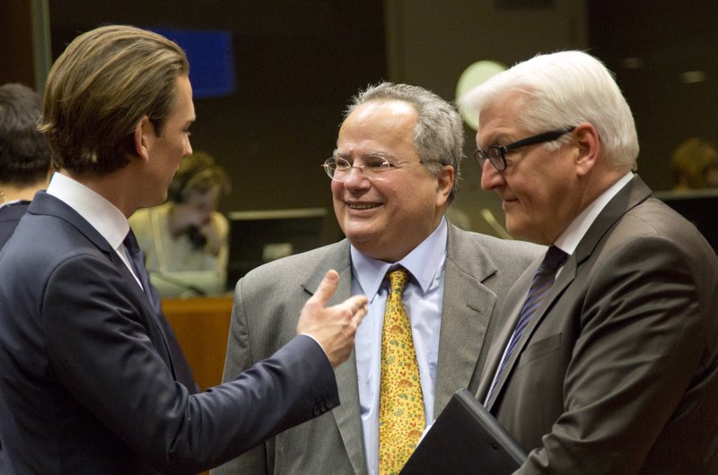 Greek Foreign Minister Nikos Kotzias, center, speaks with Austrian Foreign Minister Sebastian Kurz, left, and German Foreign Minister Frank-Walter Steinmeier, right, on Thursday during a meeting of EU foreign ministers at the EU Council building in Brussels.