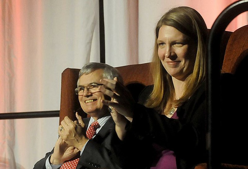 John Silva, managing director and chief economist for Wells Fargo, and Kathy Deck, director of the Center for Business and Economic Research at the University of Arkansas at Fayetteville, applaud Friday during the 21st annual Business Forecast Lunch. 