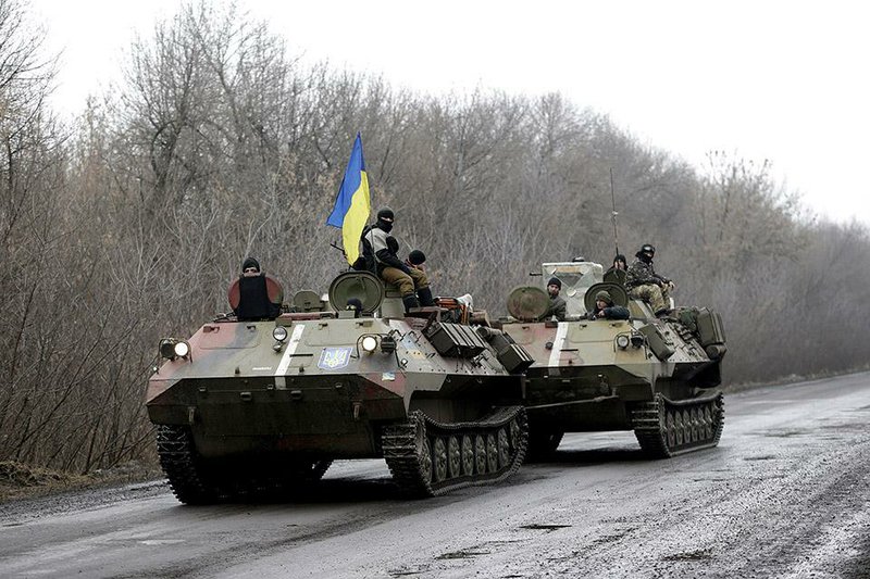 A Ukrainian armored vehicle is towed Friday toward the town of Artemivsk in eastern Ukraine, where fighting has intensified between insurgents and government troops. 