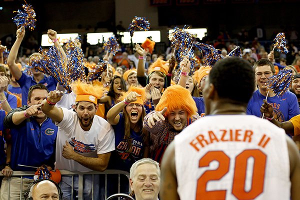 Florida guard Michael Frazier II (20) celebrates with the student section fter their 57-56 win over Arkansas in an NCAA college basketball game at the Stephen C. O'Connell Center, Saturday, Jan. 31, 2015, in Gainesville, Fla. (AP Photo/The Gainesville Sun, Matt Stamey)