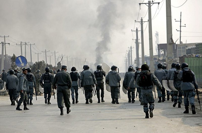 Afghan police officers in Kabul prepare Saturday to move against demonstrators protesting against the government and against the French newspaper that published caricatures of the Prophet Muhammad. 