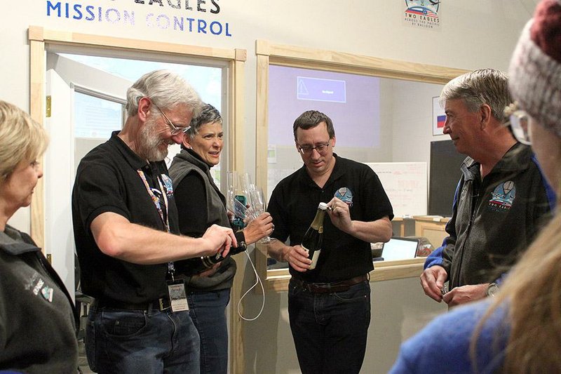 The Two Eagles Balloon mission control team in Albuquerque, N.M., prepares Saturday to pop the cork on a bottle of champagne to celebrate Saturday’s safe landing. 