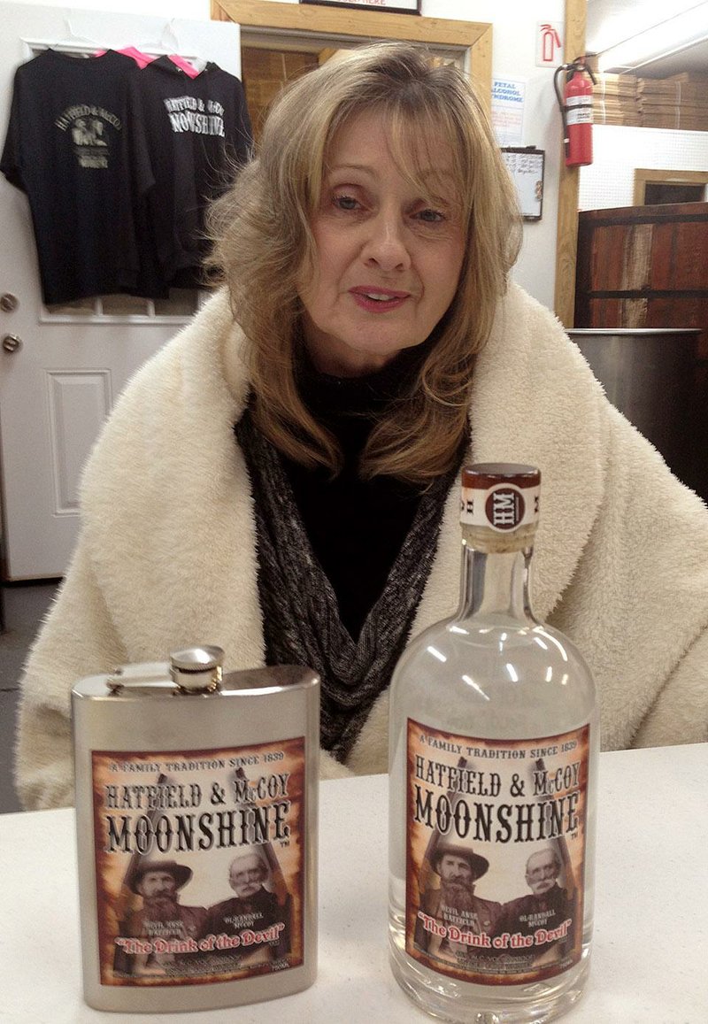 Nancy Hatfield, great-great-granddaughter of Hatfi eld patriarch William Anderson “Devil Anse” Hatfield, displays products produced at the Hatfield & McCoy distillery in Gilbert, W.Va. 