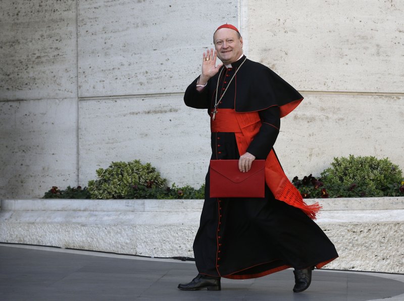 In this March 4, 2013 file photo Italian Cardinal Gianfranco Ravasi waves to reporters as he arrives for a meeting, at the Vatican. A new Vatican initiative to actually listen to women hit a sour note before it even got off the ground when an Internet promotional video featuring a sexy blonde was so ridiculed that it was quickly taken down. But the initiative is going ahead, and an inaugural meeting this week will study women's issues in ways that are utterly new for the Holy See. The latest initiative comes courtesy of Cardinal Gianfranco Ravasi, an academic who quotes Nietzsche as easily as Amy Winehouse and has no fear of courting controversy as he raises the Vatican profile in sport, art and even atheist circles at the helm of the Vatican's culture ministry.