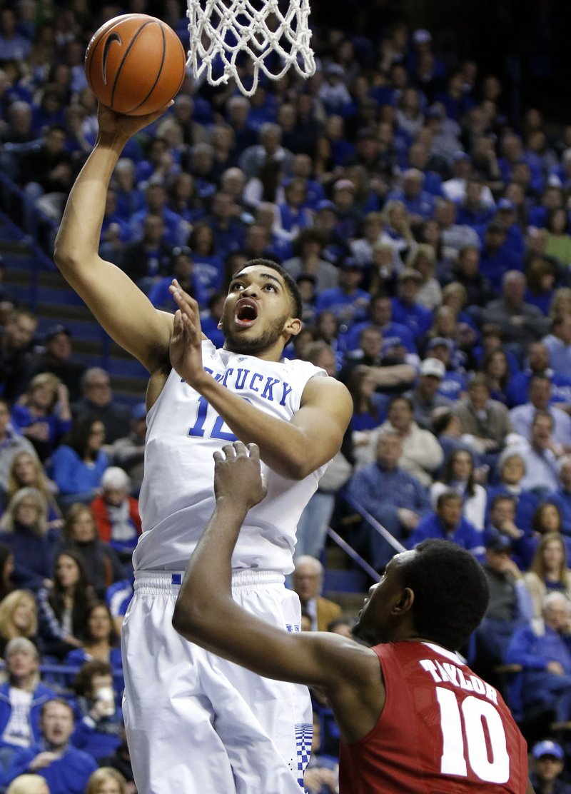 Kentucky's Karl-Anthony Towns, left, shoots over Alabama's Jimmie Taylor during the first half of an NCAA college basketball game, Saturday, Jan. 31, 2015, in Lexington, Ky.