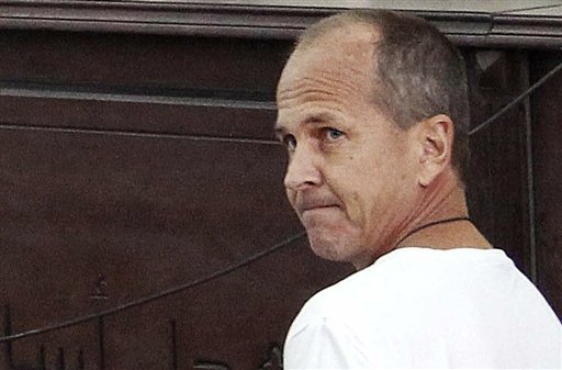 FILE - In this Monday, March 31, 2014 file photo, Al-Jazeera English correspondent Peter Greste, appears in court along with several other defendants during their trial on terror charges, in Cairo, Egypt. A senior Egyptian prison official and the country's official news agency say Greste has been freed from prison and is on his way to Cairo airport to leave the country. (AP Photo/Heba Elkholy, El Shorouk, File) EGYPT OUT