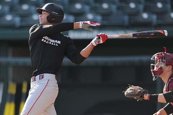 Arkansas' Luke Bonfield connects with a pitch during practice Friday, Jan. 23, 2015, at Baum Stadium in Fayetteville.