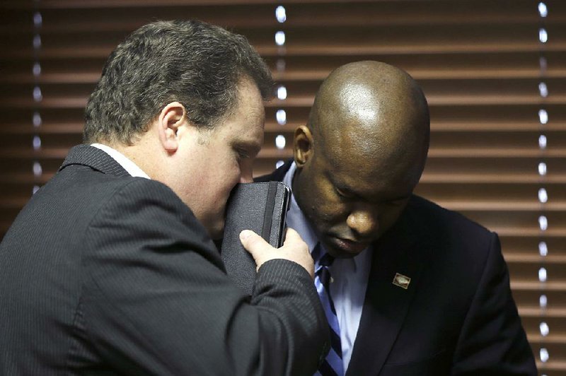 FILE - Rep. Nate Bell, R-Mena, left, speaks with Rep. Fredrick J. Love, D-Little Rock, during a meeting of the Arkansas Legislative Black Caucus, Monday, Feb. 2, 2015, in Little Rock, Ark. The representatives are sponsoring similar bills dealing with the birthday celebrations of Rev. Martin Luther King Jr. and Confederate Gen. Robert E. Lee. (AP Photo/Danny Johnston)