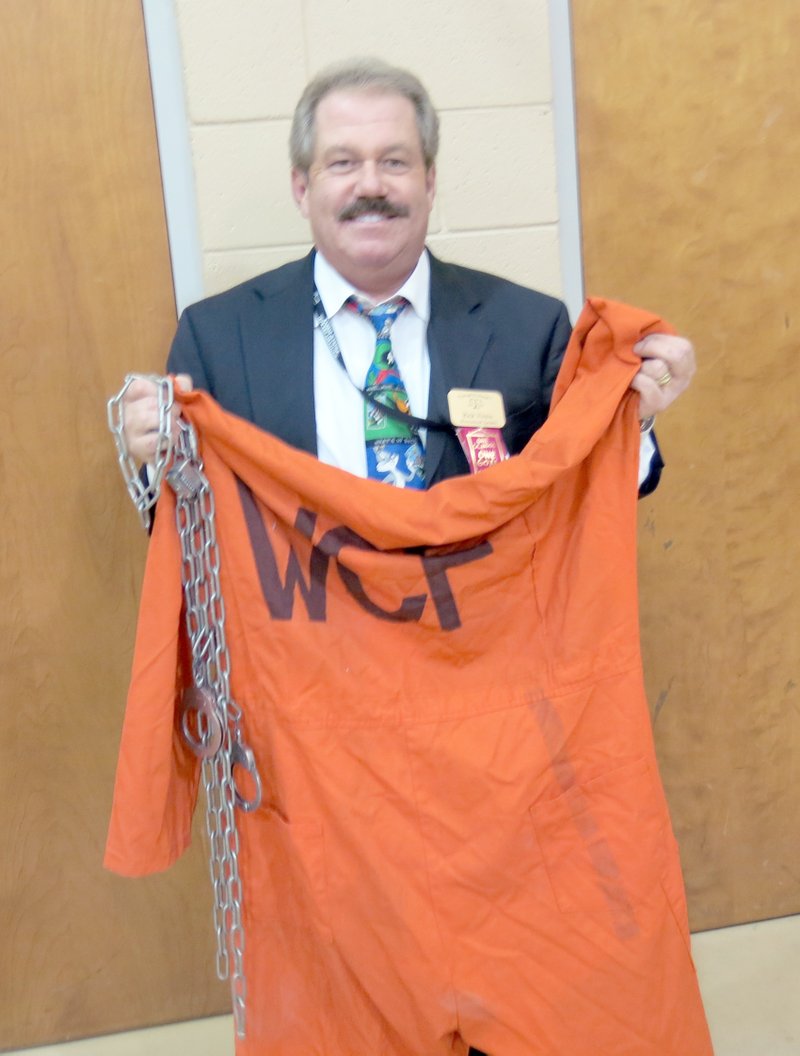 Photo by Susan Holland Rick Voisin spoke to Gravette Upper Elementary School students last month about the importance of making good choices. To help show the consequences of making the wrong choices, he displayed the orange jumpsuit and shackles he wore during his 3 1/2 years in prison. Voisin, who is now a court administrator in Kansas, emphasized that it&#8217;s never too late to change if one is on the wrong path in life.